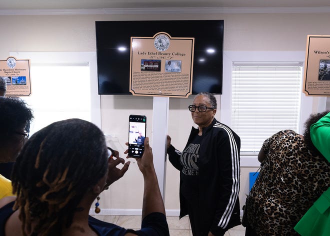 Friends and family gather around Lady Ethel Beauty College’s historical marker at Macedonia Missionary Baptist Church in Panama City, Fla., Sept. 14, 2024. The marker showcases the legacy of entrepreneurship and community spirit that defines the city’s Glenwood neighborhood. (Tyler Orsburn/News Herald)