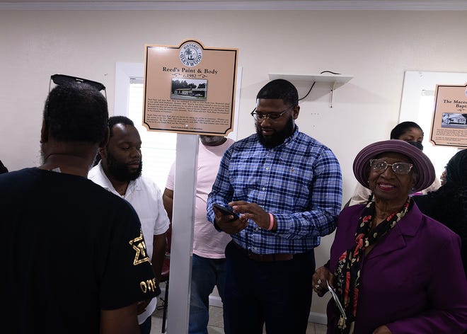 Friends and family gather around Reed’s Paint & Body historical marker at Macedonia Missionary Baptist Church in Panama City, Fla., Sept. 14, 2024. The marker showcases the legacy of entrepreneurship and community spirit that defines the city’s Glenwood neighborhood. (Tyler Orsburn/News Herald)