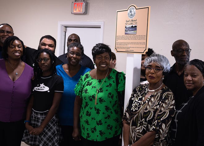 Friends and family gather around Lee’s Motel historical marker at Macedonia Missionary Baptist Church in Panama City, Fla., Sept. 14, 2024. The marker showcases the legacy of entrepreneurship and community spirit that defines the city’s Glenwood neighborhood. (Tyler Orsburn/News Herald)