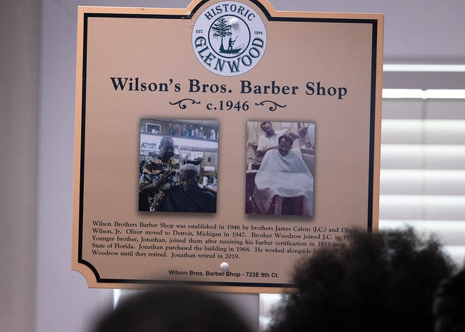 Friends and family gather around the Wilson Bros. Barber Shop’s historical marker at Macedonia Missionary Baptist Church in Panama City, Fla., Sept. 14, 2024. The marker showcases the legacy of entrepreneurship and community spirit that defines the city’s Glenwood neighborhood. (Tyler Orsburn/News Herald)