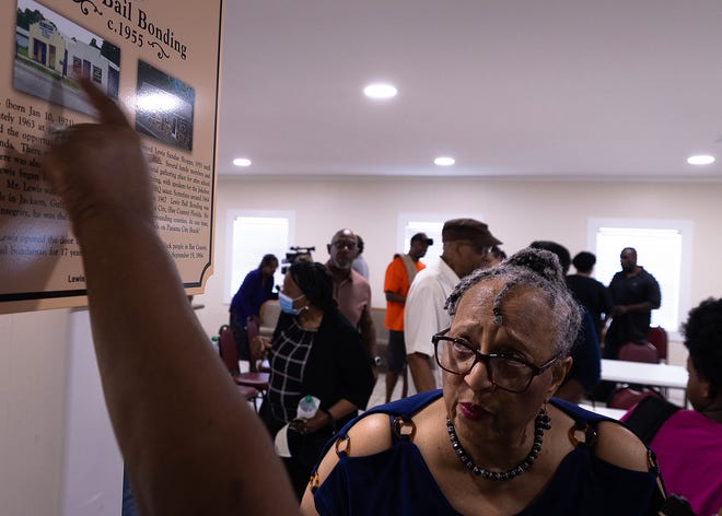 Friends and family gather around the Lewis Bail Bonding historical marker at Macedonia Missionary Baptist Church in Panama City, Fla., Sept. 14, 2024. The marker showcases the legacy of entrepreneurship and community spirit that defines the city’s Glenwood neighborhood. (Tyler Orsburn/News Herald)