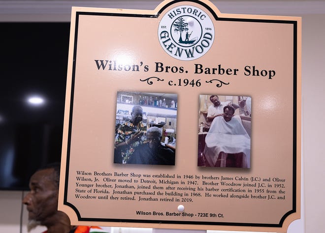 Friends and family gather around the Wilson Bros. Barber Shop’s historical marker at Macedonia Missionary Baptist Church in Panama City, Fla., Sept. 14, 2024. The marker showcases the legacy of entrepreneurship and community spirit that defines the city’s Glenwood neighborhood. (Tyler Orsburn/News Herald)