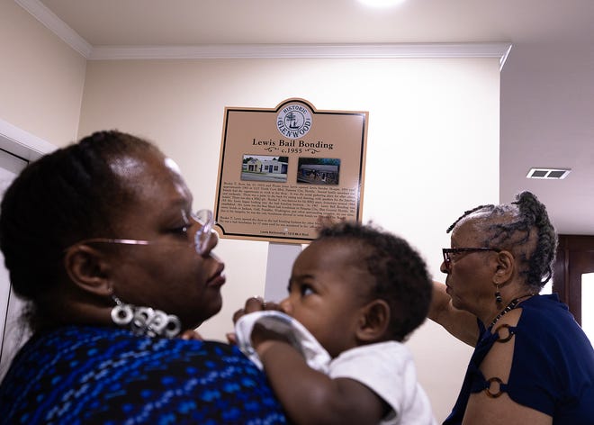 Friends and family gather around the Lewis Bail Bonding historical marker at Macedonia Missionary Baptist Church in Panama City, Fla., Sept. 14, 2024. The marker showcases the legacy of entrepreneurship and community spirit that defines the city’s Glenwood neighborhood. (Tyler Orsburn/News Herald)