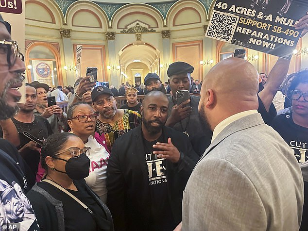 The new bills would direct the city's Commission on Racial Equity to suggest remedies to the legacy of slavery, including reparations. Pictured: Assemblymember Isaac Bryan, right, talks to members of Coalition for a Just and Equitable California about two reparations bills on August 31, 2024, in Sacramento, California