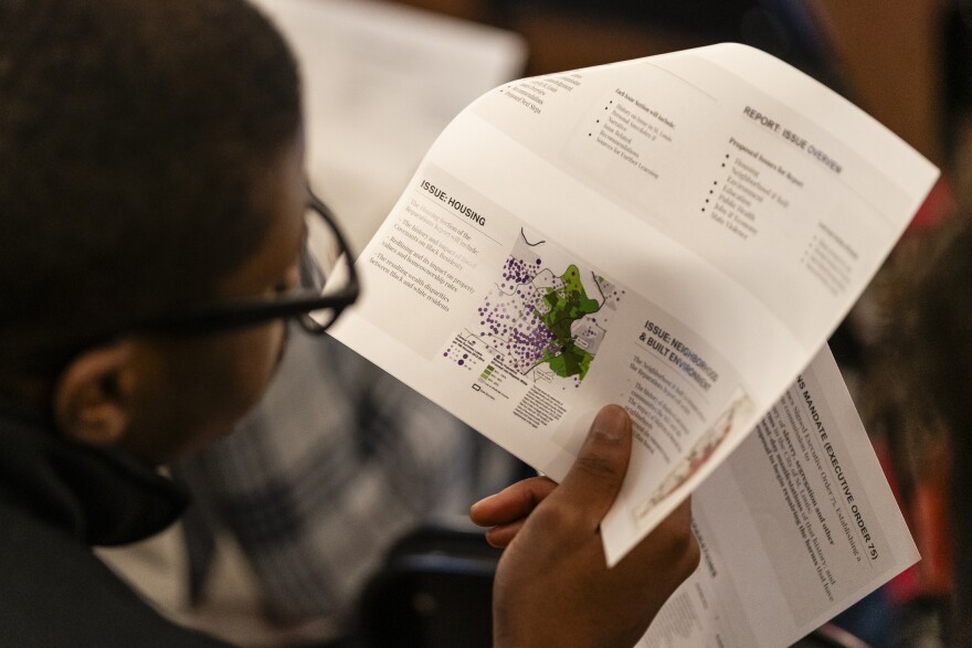 A member of the public looks at a printed version of the planned proposal during a meeting of the St. Louis Reparations Commission on Wednesday, Jan. 31, 2024, at City Hall in Downtown West. St. Louis Reparations Commission was approved by St. Louis Mayor Tishaura Jones to to extended until September 9.