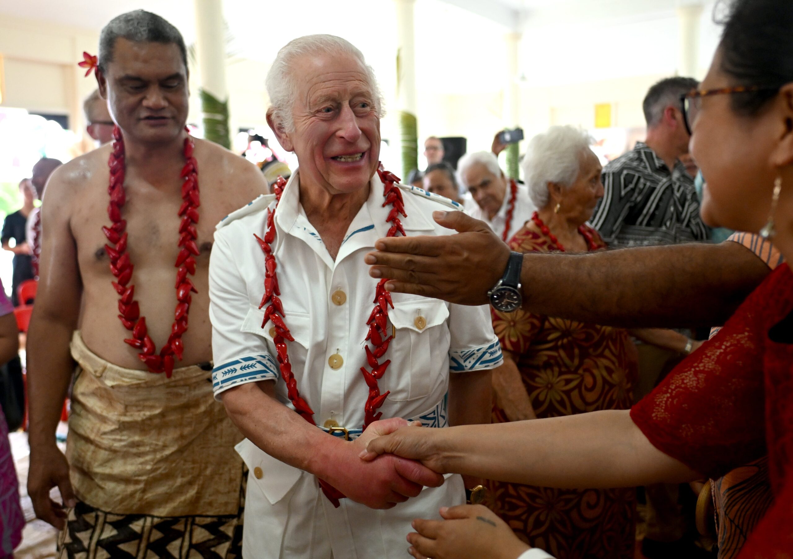 King Charles arrives at Moata’a Village for a traditional ceremonial welcome in the Church Hall