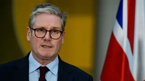 Getty Images Keir Starmer standing in front of a Union Jack