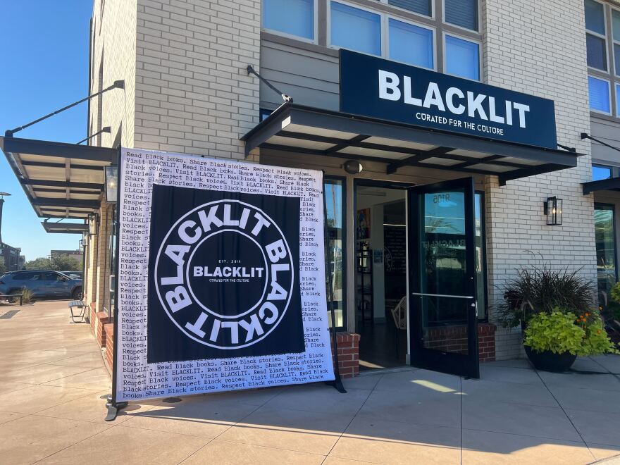 The exterior of the Blacklit bookstore in a brick building.