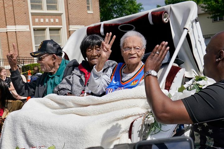 Tulsa Race Massacre survivors Hughes Van Ellis Sr. (left), Lessie Benningfield Randle (center) and Viola Fletcher wave at supporters from a horse-drawn carriage in Tulsa, Oklahoma, on May 28, 2021.