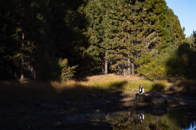 Jade Stevens rests near Lake Putt, a main attraction among the 650 acres of land owned and managed by 40 Acre League. October 25, 2024.