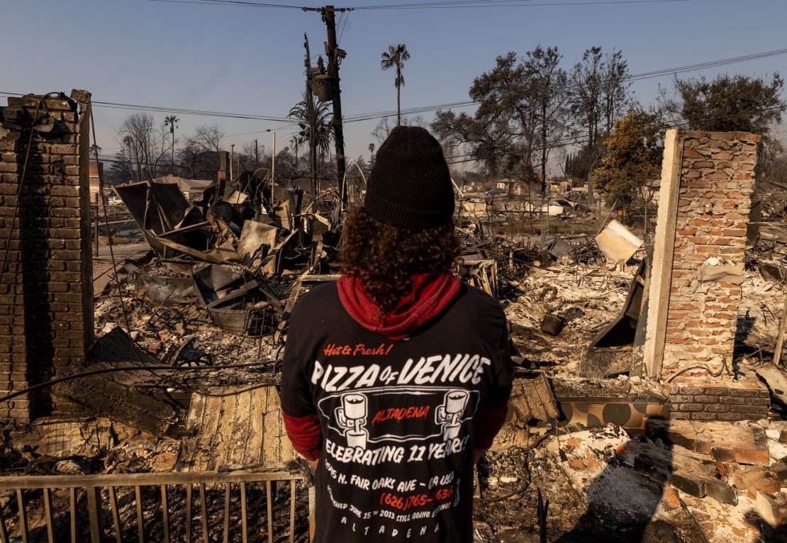 The owner of Pizza Of Venice visits his restaurant, which burned down in the Eaton Fire, on January 11 in Altadena.