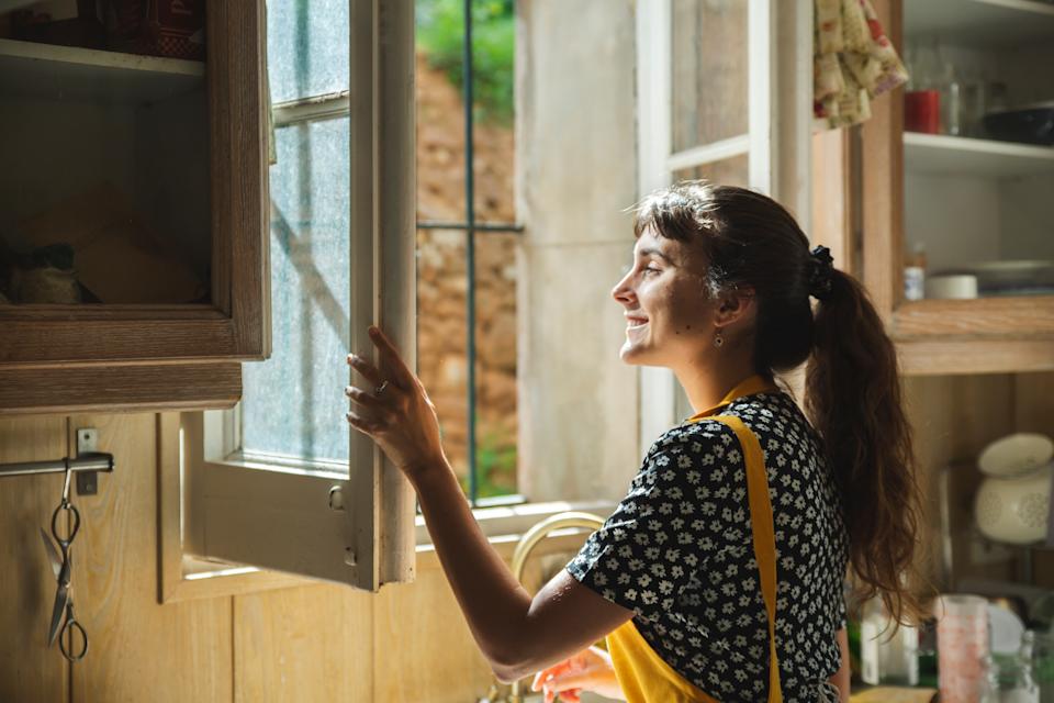 Woman opening a window. 