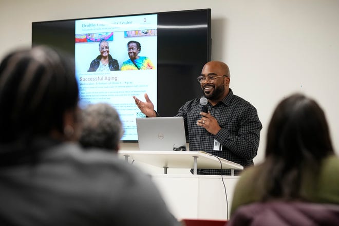 Javonte McDonald welcomes attendees to the Black Health: A Journey Through Time event at the Healthy Community Center on the Near East Side on Feb. 11, 2025. The program looked at the historical challenges and progress of Black health care.